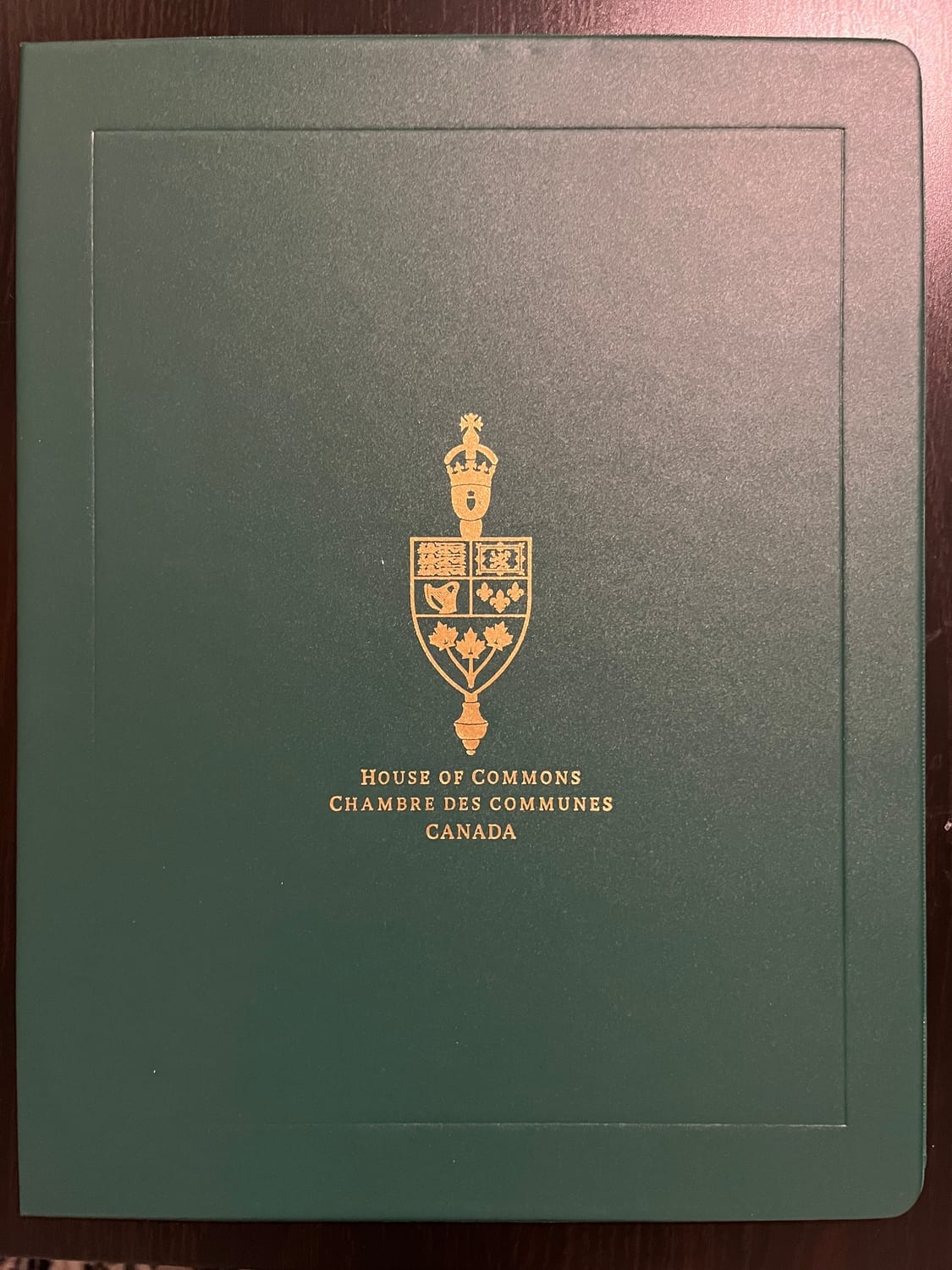 The green and gold House of Commons of Canada presentation folio the Diwali certificates were awarded in.